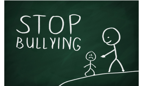 chalkboard with stick figure helping smaller stick figure up and lettering of Stop Bullying 